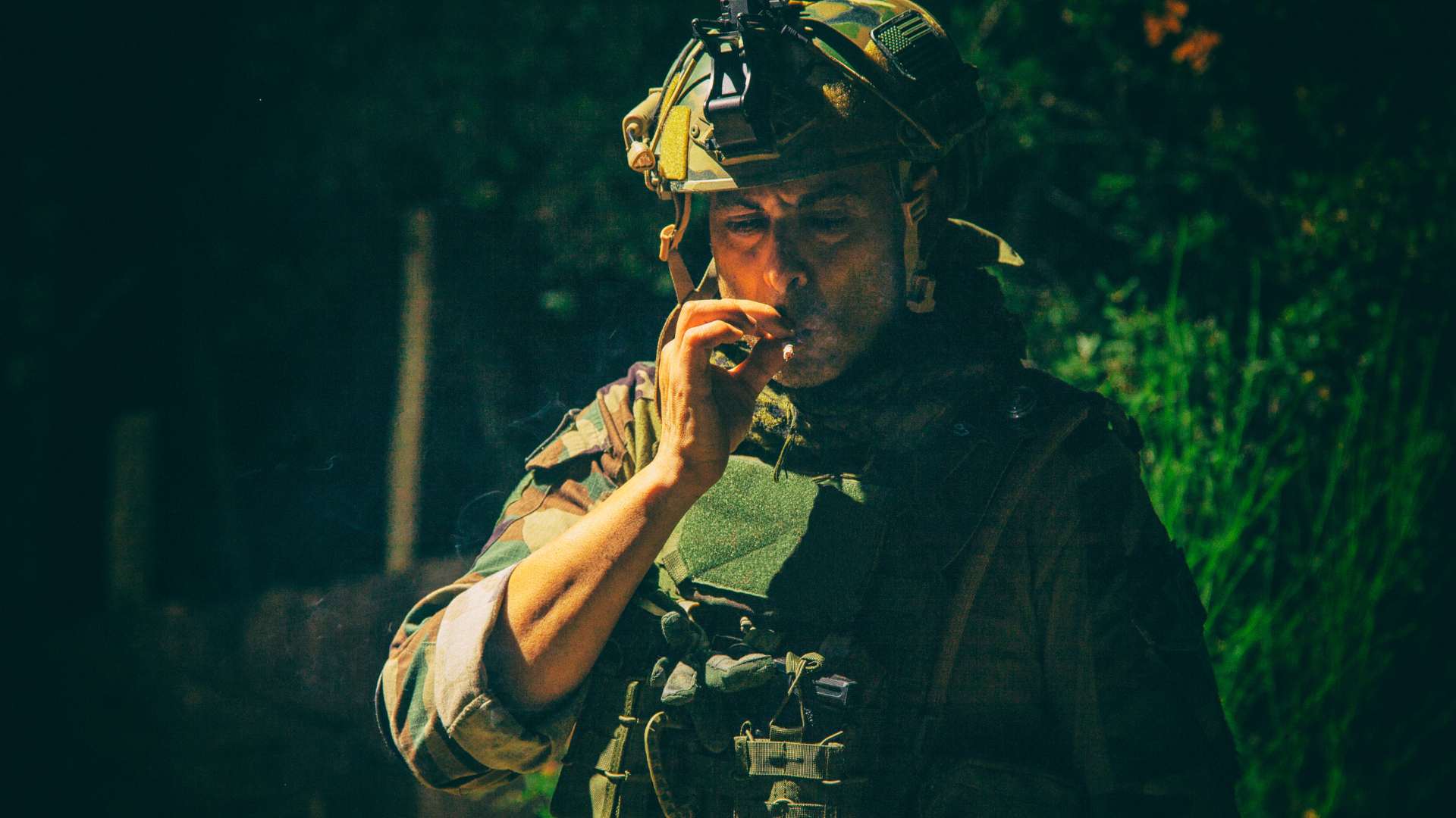 low-light vision of soldier smoking cigarrete