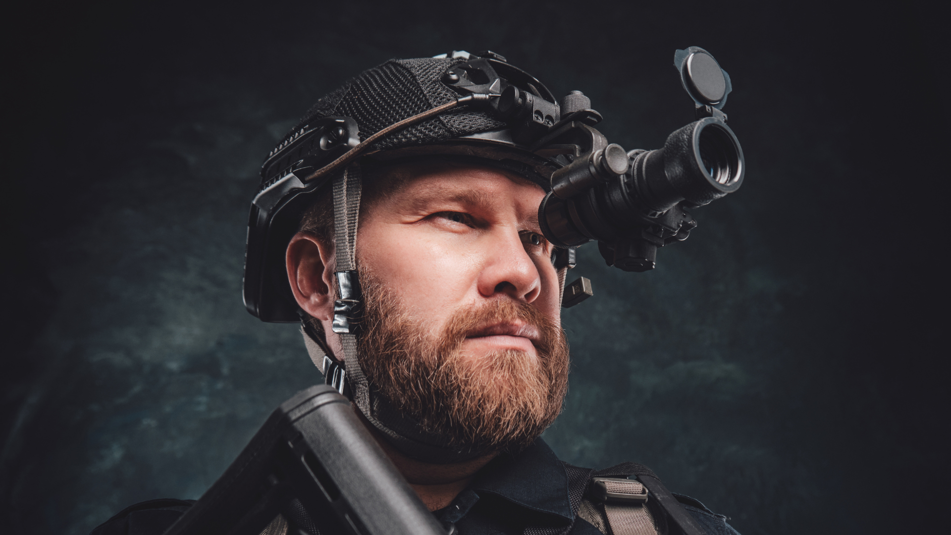 modern soldier looks in night vision device inbuilt in his helmet