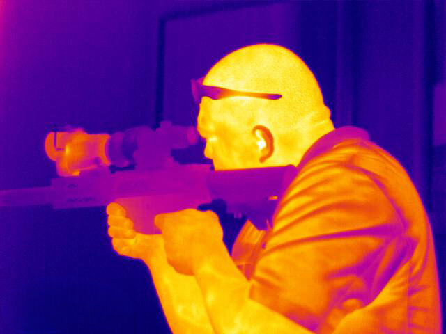 thermal image of man with rifle